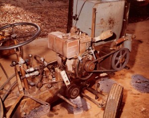 Front of a Sears Suburban Tracker showing the PTO and hydraulics of our wood splitter. The controls for the compressor are located just under the steering wheel.